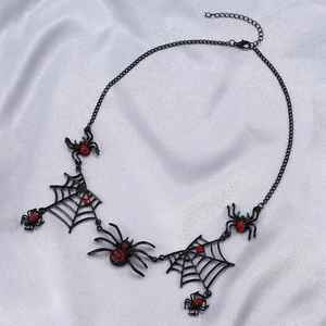 Gothic Halloween black spiderweb necklace with red rhinestones on light fabric