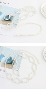 Close-up of elegant white pearl waist chain with hollow wreath metal buckle for dresses