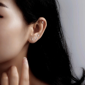 Minimalist S999 sterling silver LOVE letter stud earrings set worn on ear cartilage