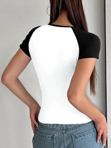 Back view of a slim fit Y2K raglan sleeve t-shirt in black and white contrast colors