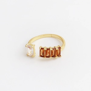 Detail view of gold open ring with rectangle amber and clear zircon gemstone settings