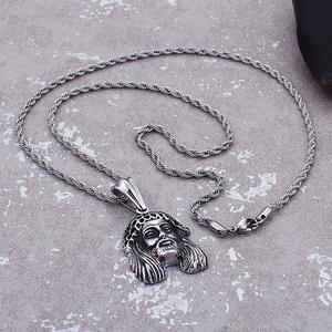 Detail of vintage silver titanium steel Jesus head pendant on rope chain necklace