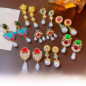 Detailed collection of vintage gold plated earrings with pearls and colorful gemstones