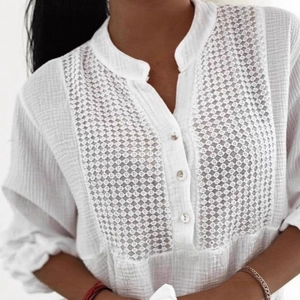 Detailed close-up of white lace patchwork on a cotton shirt with elegant hollow textures