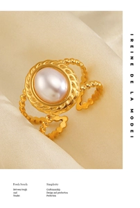 Detail view of oval white pearl gold ring on cream silk with beaded band design