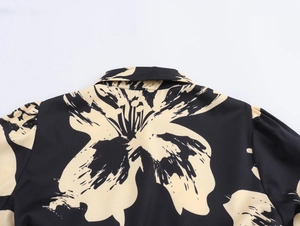 Detailed view of the turnover collar and floral print on women's shirt dress