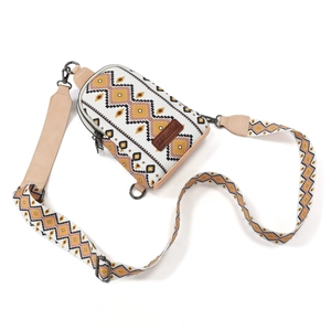 Detail of bohemian canvas crossbody bag with geometric diamond patterns and leather trim