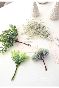 Detailed close-up of artificial frosted pine branches and green fir needles for DIY Christmas decor