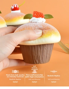 Close-up of realistic strawberry cupcake squishy toy being squeezed by hand for stress relief