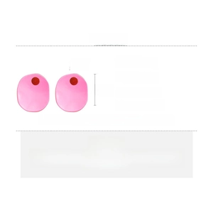 Detail showing dimensions of pink resin oval earrings with silver needles and red dots