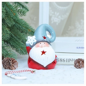Close-up of star-shaped hollowed Christmas Santa gnome figurine on festive table decor