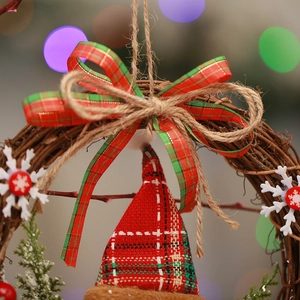 Macro shot of a rustic Christmas wreath with rattan base and red-green plaid fabric bow