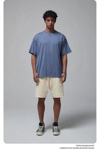 Full view of blue oversize cotton T-shirt paired with beige drawstring shorts on model