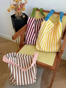 Striped knit canvas tote bags with colorful ruffled handles in vintage home setting