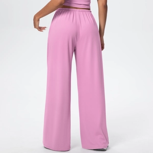 Rear view of pink wide-leg sweatpants featuring high waist and loose-fit draped fabric