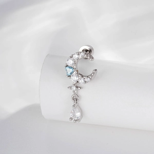 Vintage crescent moon and teardrop zircon stud earring on a white cylindrical stand