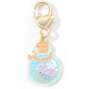 Detail of blue jellyfish enamel charm inside glass bottle with gold heart lobster clasp