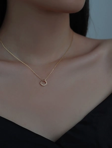 Detailed view of a S925 silver square necklace with 14k gold plating and micro-pave crystals
