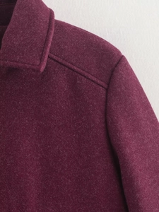 Detail of burgundy wool blend jacket showing high-quality double stitching and texture