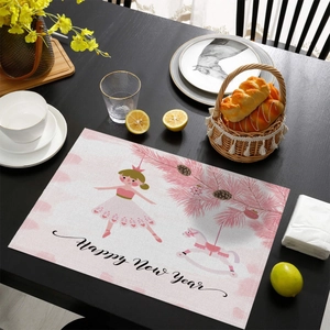 Pink festive placemat featuring ballet dancer and Christmas tree motifs on a wooden table