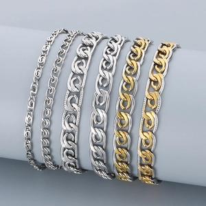 Set of six stainless steel paperclip chains in gold and silver colors on grey stand