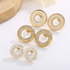 Detailed set of three golden geometric hoop earrings with sparkling rhinestones in three sizes