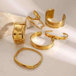 Minimalist gold plated stainless steel bangles set featuring geometric and wave designs