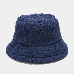 Detailed texture of thick navy blue lamb wool fabric on a warm winter bucket hat