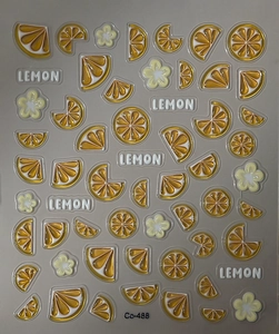 Macro shot of 3D embossed lemon slice stickers and white floral nail art decals
