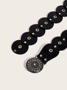 Detail of western retro belt showing floral rhinestone buckle and studded black round links