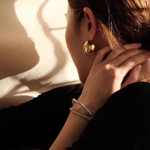 Fashionable gold chunky hoop earrings and silver cable bracelet set for elegant women