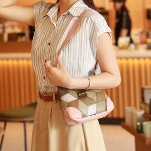 Retro patchwork underarm bag for women with pink trim and geometric textured pattern
