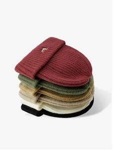 Close-up of ribbed knit beanies in various colors with cute fox embroidery detail