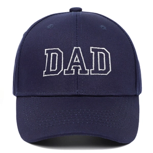 Detailed close-up of white DAD embroidery on a navy blue cotton baseball cap with stitching