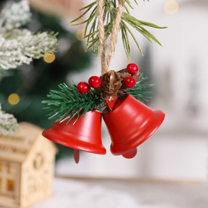 Detail of red Christmas bells with natural pine cones and berries on snowy background