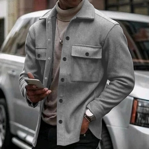 Detail of dark grey wool texture jacket with double chest pockets and lapel collar