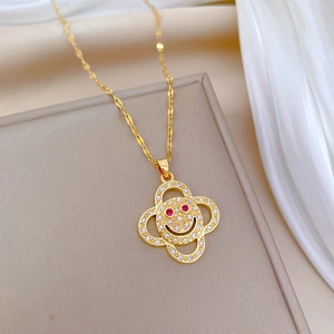 Luxurious gold flower smiley necklace with red and clear crystals on silk and jewelry box