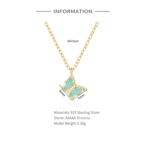 Macro view of gold S925 silver butterfly pendant with blue zircon stones and detail specs