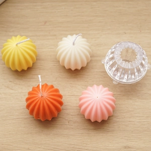 Detailed view of spherical acrylic candle molds and colorful cactus shaped wax candles