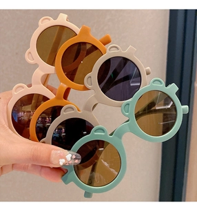 Detail of round toddler sunglasses with bear ear design in various matte pastel colors