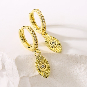 Exquisite 18K gold plated eye earrings with sparkling zircon on white stone surface