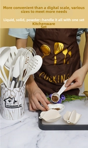 Close-up of marble pattern kitchen tool holder with white silicone utensils and whisk