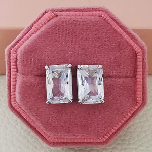 Close-up of square zircon stud earrings with classic four-prong setting in pink velvet box
