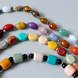 Macro detail of colorful resin beads showing marble textures and glossy finishes