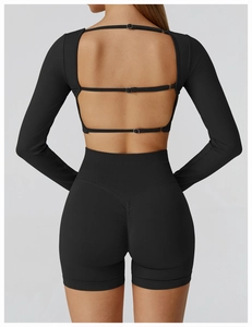 Detail of black seamless yoga set with open back straps and scrunch butt gym shorts