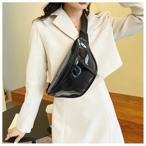 Detail of glossy black patent leather chest bag featuring metallic zipper and wide strap
