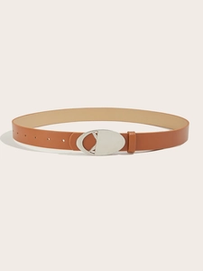 Detail of a brown leather belt featuring a polished silver oval hollow metal buckle