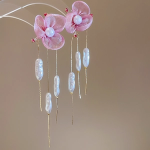 Detail of pink chiffon flower earrings with pearls and long tassel golden chains