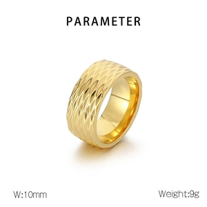 Macro shot of 10mm wide gold titanium ring with geometric diamond-cut texture details