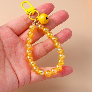 Close-up of handmade yellow beaded keychain featuring a metal clasp and matching yellow bell